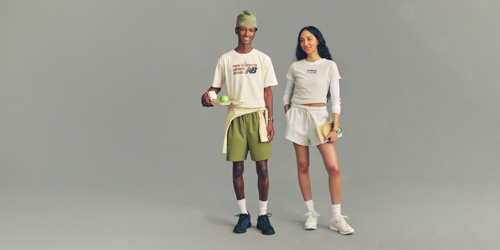 Two people standing dressed in Lifestyle apparel and footwear